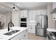 Kitchen with stainless refrigerator, microwave, oven and large sink with white cabinets at 1024 Country Pasture Cv, Wendell, NC 27591