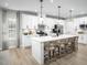 Bright kitchen with white cabinets, stainless steel appliances, and a large island with seating at 1024 Country Pasture Cv, Wendell, NC 27591