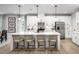Bright kitchen with white cabinets, stainless steel appliances, and large island with seating at 1024 Country Pasture Cv, Wendell, NC 27591