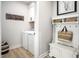 Bright laundry room and mudroom with white cabinets, laundry machine, and bench at 1024 Country Pasture Cv, Wendell, NC 27591