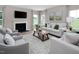 Bright living room with large windows, fireplace, comfortable seating and stylish decor at 1024 Country Pasture Cv, Wendell, NC 27591