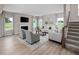 Spacious living area with modern fireplace, comfortable seating, and staircase leading to the upper level at 1024 Country Pasture Cv, Wendell, NC 27591