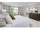 Serene main bedroom with large windows, comfortable seating, and a view into the en suite bathroom at 1024 Country Pasture Cv, Wendell, NC 27591