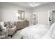 Comfortable primary bedroom featuring a patterned comforter, soft lighting, and a view into the ensuite bath at 1024 Country Pasture Cv, Wendell, NC 27591