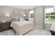 Calming main bedroom with neutral tones, two windows, and plush carpeting at 1024 Country Pasture Cv, Wendell, NC 27591