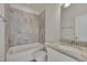 Clean bathroom with granite countertop, white vanity, and bathtub at 106 Park Manor Ln, Cary, NC 27519