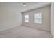 Bright bedroom with two windows and neutral color scheme at 106 Park Manor Ln, Cary, NC 27519