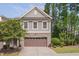 Gray townhome exterior with brown garage door and landscaping at 106 Park Manor Ln, Cary, NC 27519