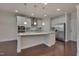 Modern kitchen with large island, stainless steel appliances, and hardwood floors at 106 Park Manor Ln, Cary, NC 27519