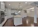 Open concept kitchen with island, stainless steel appliances, and white cabinets at 106 Park Manor Ln, Cary, NC 27519