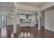 Open concept kitchen with island, stainless steel appliances, and hardwood floors at 106 Park Manor Ln, Cary, NC 27519