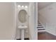 Small powder room with pedestal sink and oval mirror at 106 Park Manor Ln, Cary, NC 27519