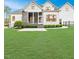 Well-maintained backyard features a stone-accented screened porch and lush green lawn at 120 Crosby Ln, Sanford, NC 27330