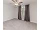 Bedroom featuring neutral carpet, ceiling fan and a window with gray drapes at 120 Crosby Ln, Sanford, NC 27330