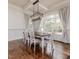 Bright dining room with hardwood floors, modern lighting, and large window with lots of natural light at 120 Crosby Ln, Sanford, NC 27330