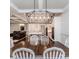 Open floor plan shows the dining room leading into the kitchen and living area with a modern light fixture at 120 Crosby Ln, Sanford, NC 27330