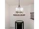 Bright entryway boasting a modern chandelier and black front door at 120 Crosby Ln, Sanford, NC 27330