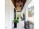 Covered porch with stone columns and dark stained ceiling at 120 Crosby Ln, Sanford, NC 27330