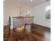 Hallway featuring hardwood floors, staircase, and chandelier with ample natural light at 120 Crosby Ln, Sanford, NC 27330