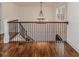 Hallway featuring hardwood floors, staircase, and chandelier with ample natural light at 120 Crosby Ln, Sanford, NC 27330