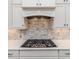 This modern kitchen has granite countertops, tiled backsplash, gas range, and white cabinetry at 120 Crosby Ln, Sanford, NC 27330