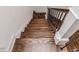 Staircase featuring hardwood steps, white risers and black metal railing at 120 Crosby Ln, Sanford, NC 27330