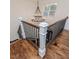 Staircase showcasing hardwood steps, white pillars, and a modern chandelier at 120 Crosby Ln, Sanford, NC 27330