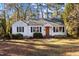 White single story home with a classic design and well-maintained lawn at 1325 Duplin Rd, Raleigh, NC 27607