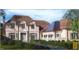Elegant two-story home with a three-car garage and manicured landscaping at 1521 Canterbury Rd, Raleigh, NC 27608