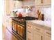 Luxury kitchen with marble countertops and a large range at 1521 Canterbury Rd, Raleigh, NC 27608