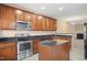 Kitchen with island, stainless steel appliances, and granite countertops at 1673 Snowmass Way, Durham, NC 27713