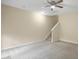Bright living room featuring carpet, ceiling fan, and staircase at 1673 Snowmass Way, Durham, NC 27713