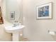 Small bathroom with pedestal sink, art, and plenty of counter space at 2112 White Pond Ct, Apex, NC 27523