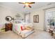 Comfortable bedroom featuring a cozy bed, ample natural light, and soft neutral colors at 2112 White Pond Ct, Apex, NC 27523