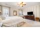Spacious bedroom with large windows, a ceiling fan, and neutral decor at 2112 White Pond Ct, Apex, NC 27523