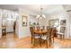Bright dining area with hardwood floors and views into the kitchen and entryway at 2112 White Pond Ct, Apex, NC 27523