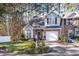 Brick front townhouse with driveway, landscaping, and white picket fence at 2112 White Pond Ct, Apex, NC 27523