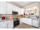 Modern kitchen with white cabinets, stainless steel appliances, and granite countertops at 2112 White Pond Ct, Apex, NC 27523