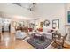Open-concept living and dining area featuring hardwood floors, high ceilings, and a fireplace at 2112 White Pond Ct, Apex, NC 27523
