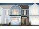Two-story townhome with gray siding, brick accents, and a two-car garage at 248 Broomside Ave, Raleigh, NC 27603