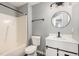 Clean bathroom, featuring a vanity with a round mirror and bathtub at 2862 Filbert St, Raleigh, NC 27610