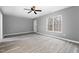 Bright bedroom with gray walls, wood-look floors, and large window at 2862 Filbert St, Raleigh, NC 27610