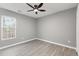 Well-lit bedroom with ceiling fan and window overlooking trees at 2862 Filbert St, Raleigh, NC 27610