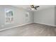 Spacious bedroom with gray walls, wood-look floors and ceiling fan at 2862 Filbert St, Raleigh, NC 27610