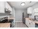 Modern kitchen with white cabinets, butcher block countertops, and stainless steel appliances at 2862 Filbert St, Raleigh, NC 27610