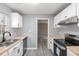 Modern kitchen with white cabinets, butcher block countertops, and stainless steel appliances at 2862 Filbert St, Raleigh, NC 27610