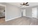 Main bedroom with gray walls, wood-look floors, and ceiling fan at 2862 Filbert St, Raleigh, NC 27610
