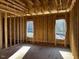 Interior framing of a room under construction, featuring three large windows at 30 Seahawk Way, Zebulon, NC 27597