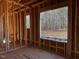 Interior framing of a room under construction, showing a large window at 30 Seahawk Way, Zebulon, NC 27597