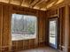 Interior framing of a room under construction, featuring a door and large window at 30 Seahawk Way, Zebulon, NC 27597